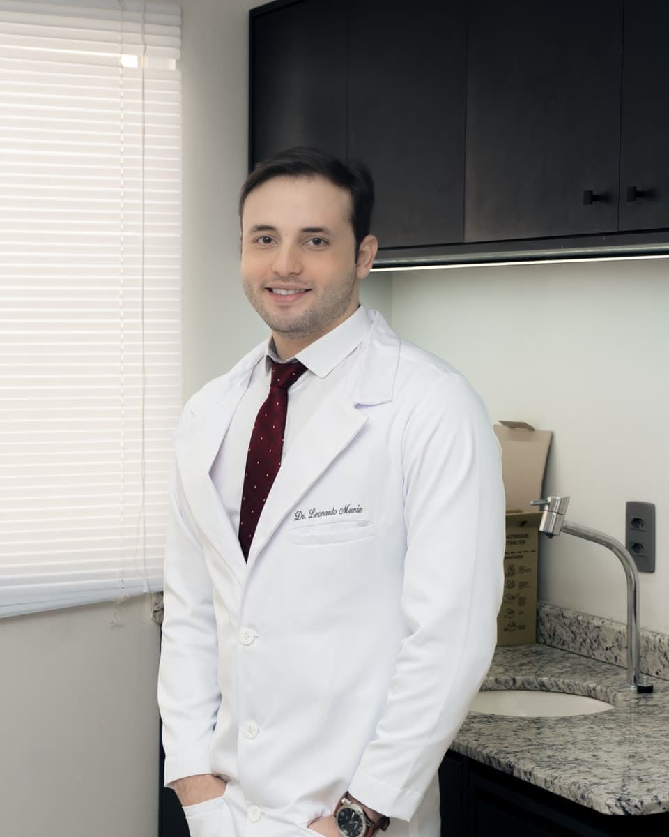 Healthcare professional in a white coat working in a bright laboratory